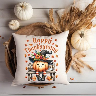 a white pillow with a happy thanksgiving pumpkin on it