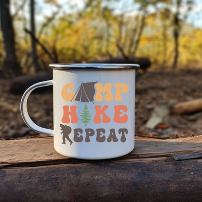 a camp coffee mug sitting on top of a log