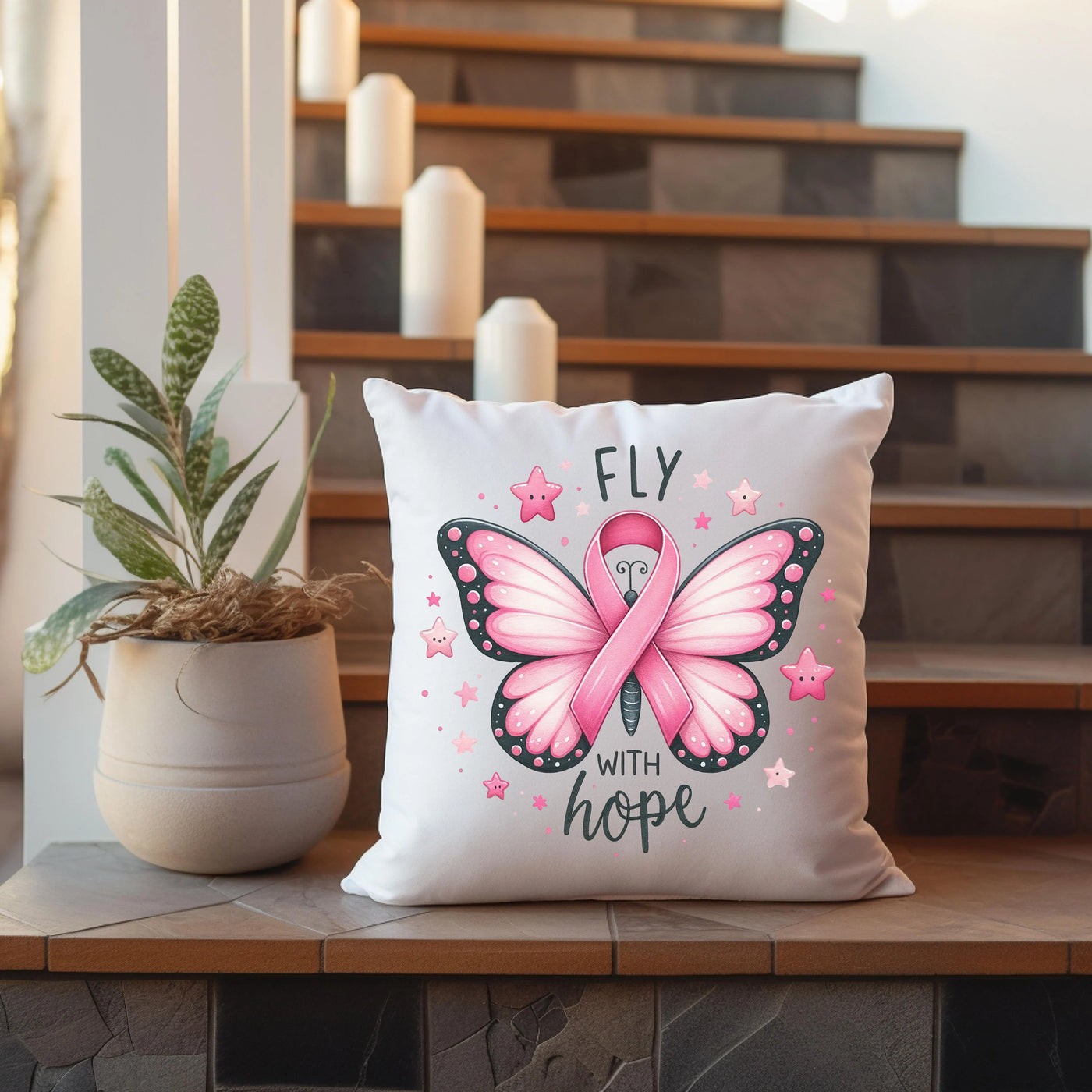 a pink butterfly pillow sitting on top of a wooden table