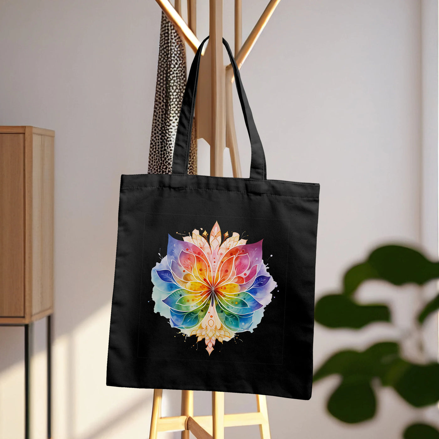 a black tote bag with a colorful flower on it