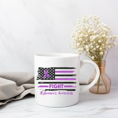 a white coffee mug with a purple ribbon on it