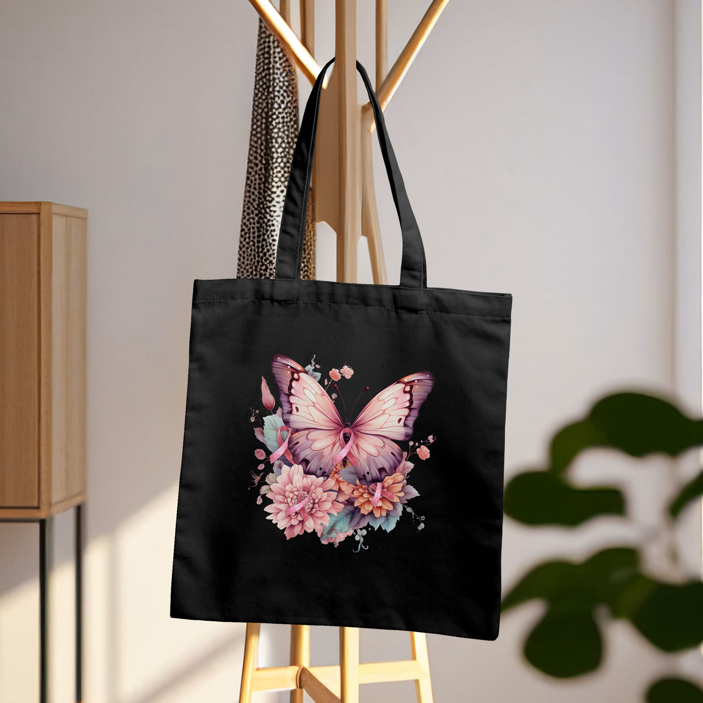 a black tote bag with a butterfly and flowers on it