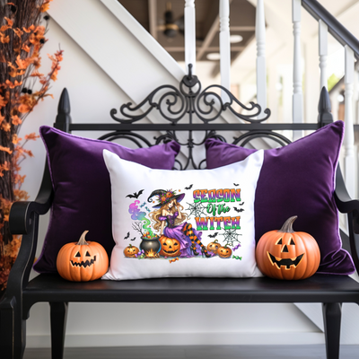 a bench with two pumpkins and a pillow on it