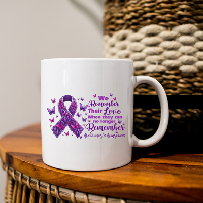 a white coffee mug with a purple ribbon on it