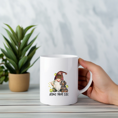 a person holding a coffee mug with a gnome on it