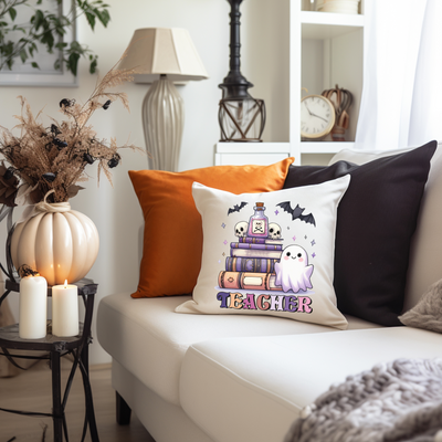 a living room with a white couch and a halloween pillow