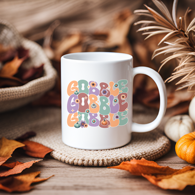 a white coffee mug sitting on top of a table