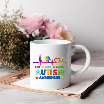 a white coffee mug with the words autism on it