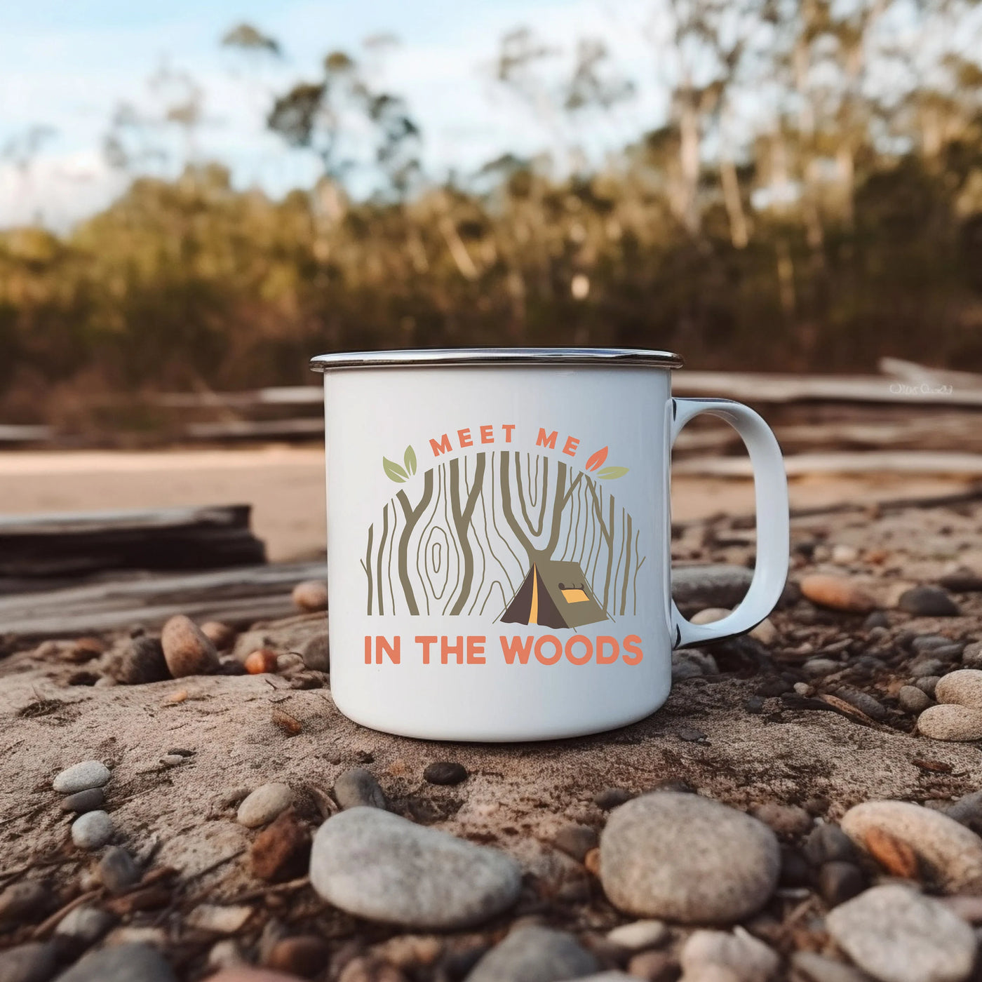 a white coffee mug sitting on top of a pile of rocks