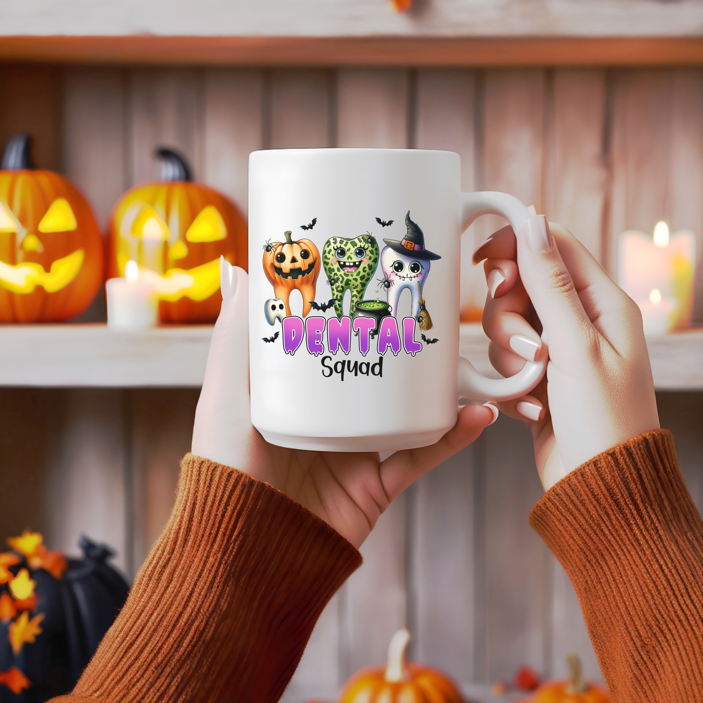 a person holding a coffee mug with a picture of cats and pumpkins on it