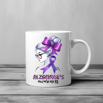 a white coffee mug with a purple ribbon on it