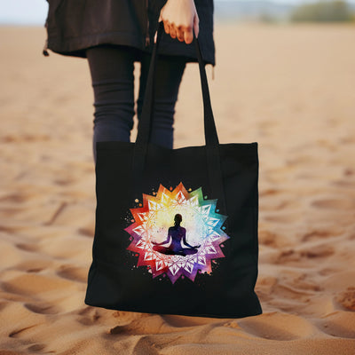 a woman carrying a black tote bag with a picture of a person doing yoga