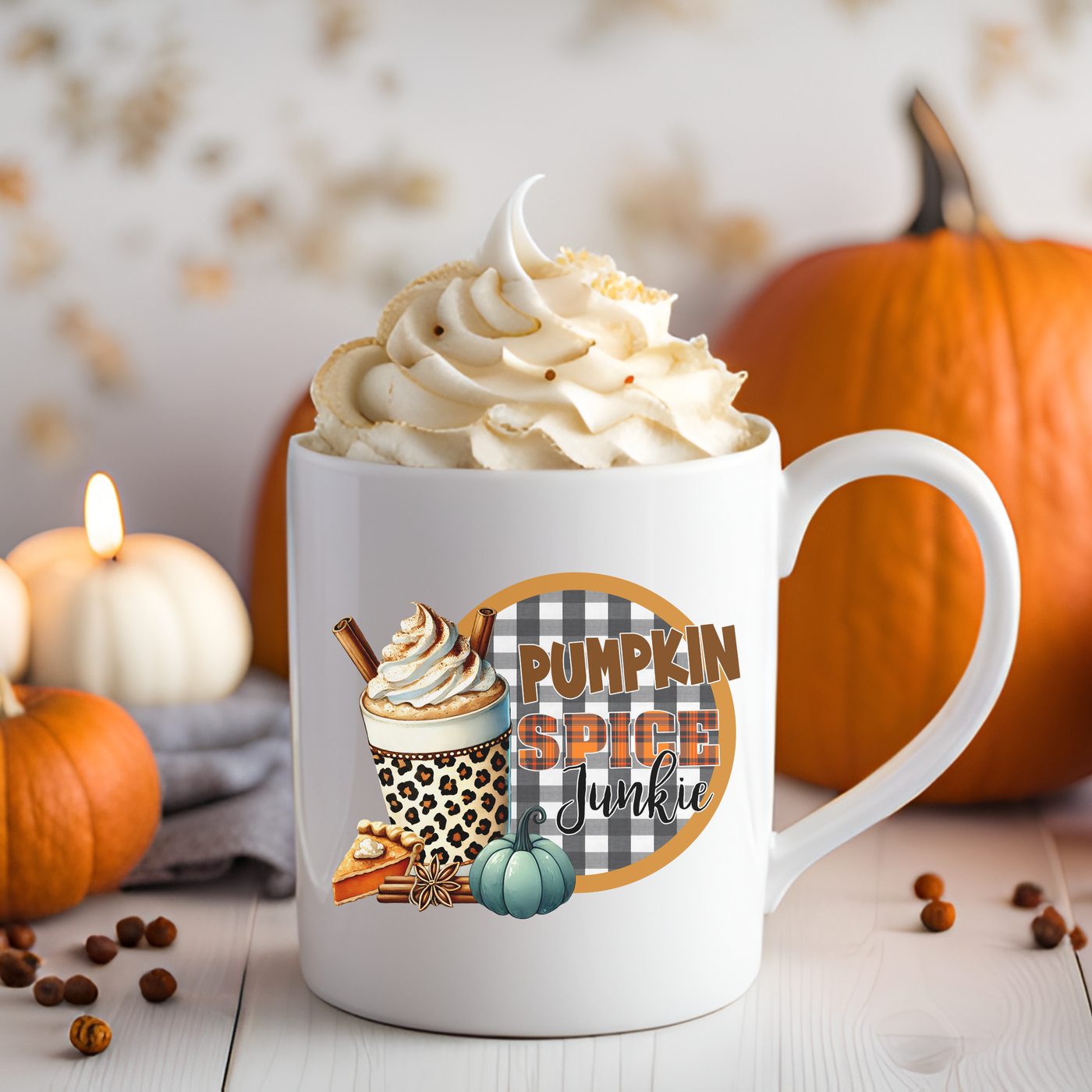 a cup of pumpkin spice coffee next to pumpkins