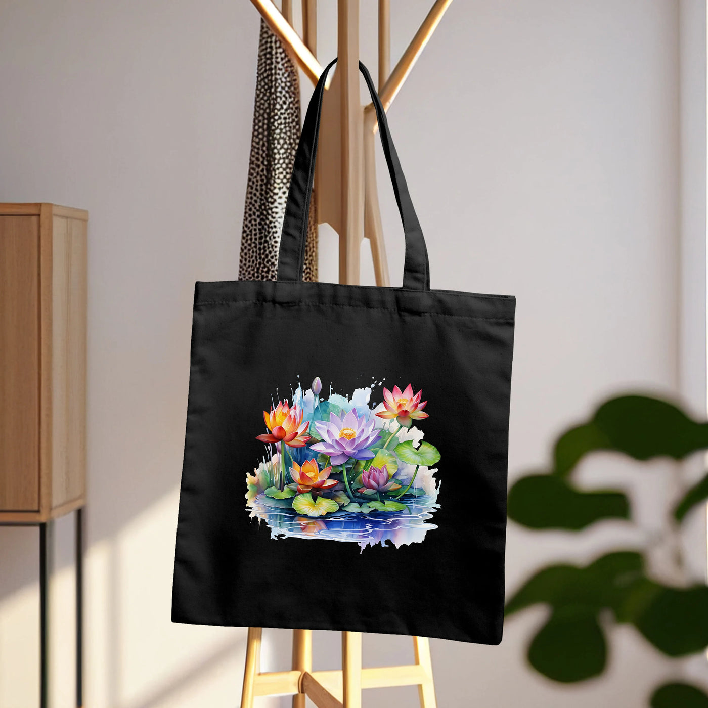 a black tote bag hanging on a clothes rack