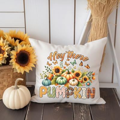 a white pillow with a pumpkin and sunflowers on it