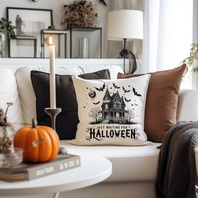 a white couch with a halloween pillow on it