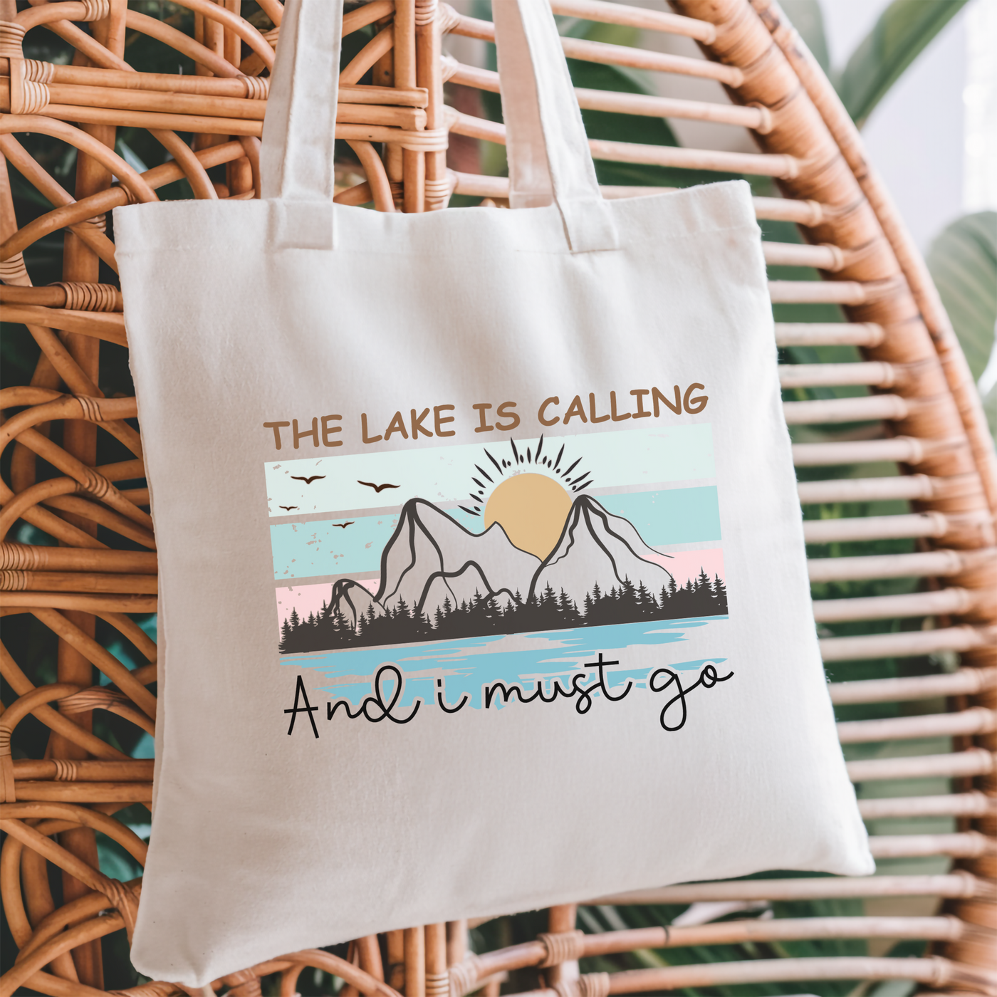 a white tote bag with the words, the lake is calling and i must