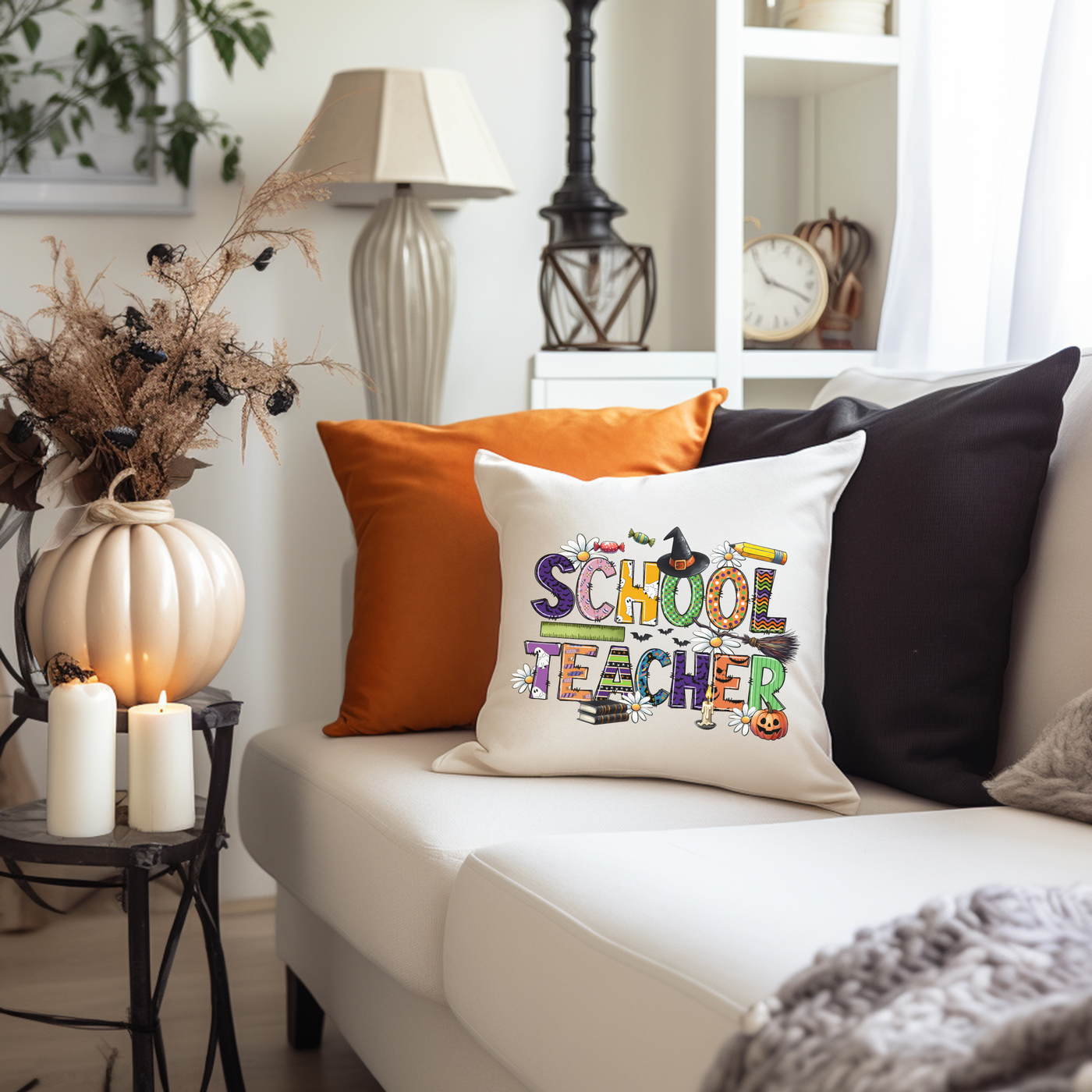 a living room with a white couch and a black and orange pillow