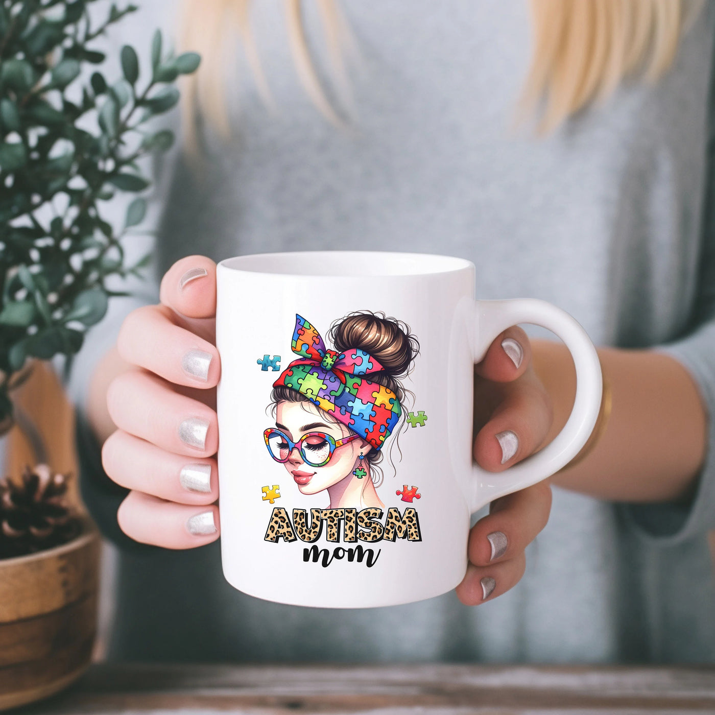 a woman holding a coffee mug with the words autism on it