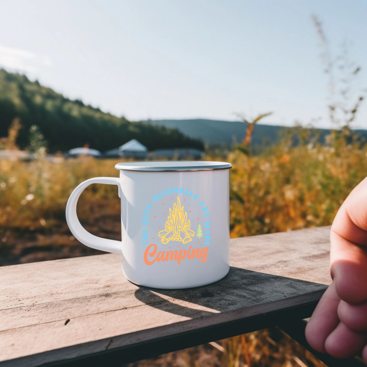 a person holding a coffee mug on a wooden table