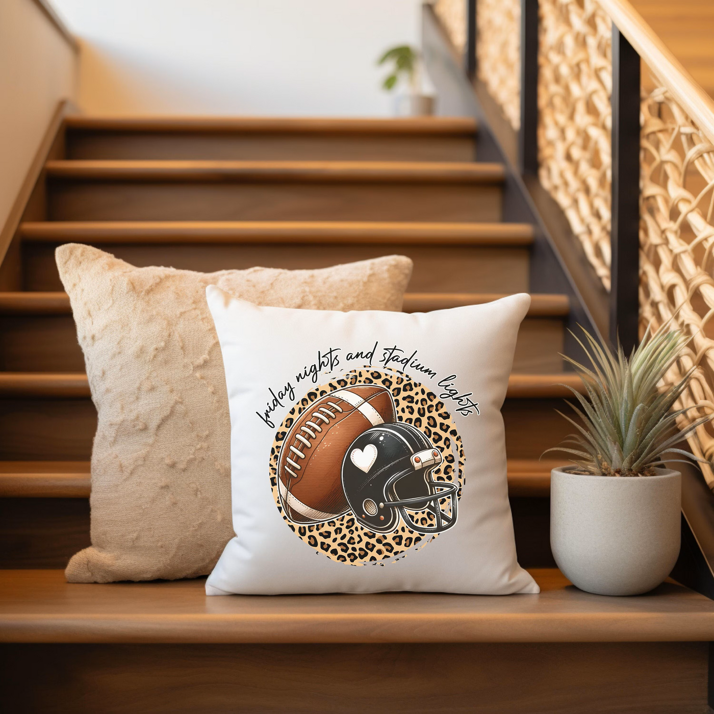 a pillow with a football on it sitting on a set of stairs