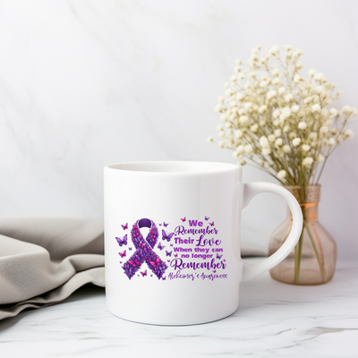 a white coffee mug with a purple ribbon on it