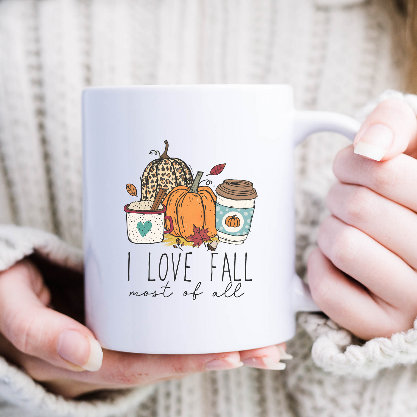 a woman holding a coffee mug with a fall theme