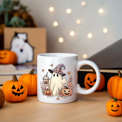 a white coffee mug with a ghost and pumpkins around it