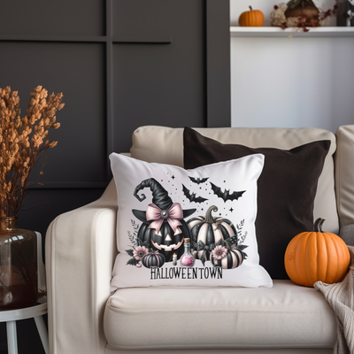 a white couch with a halloween pillow on it