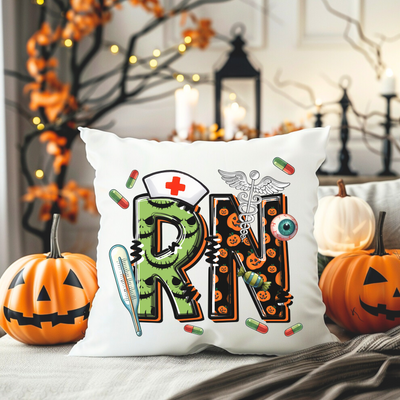 a pillow with the word rn on it next to two pumpkins