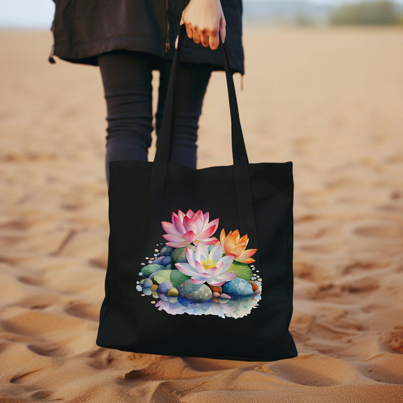 a woman carrying a black tote bag with flowers on it