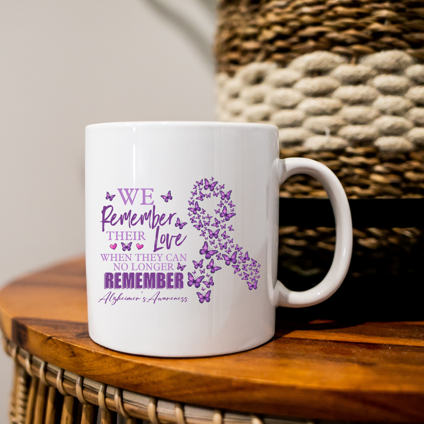 a white coffee mug with a purple ribbon on it