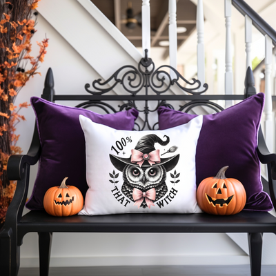 a bench with two pumpkins and a pillow on it