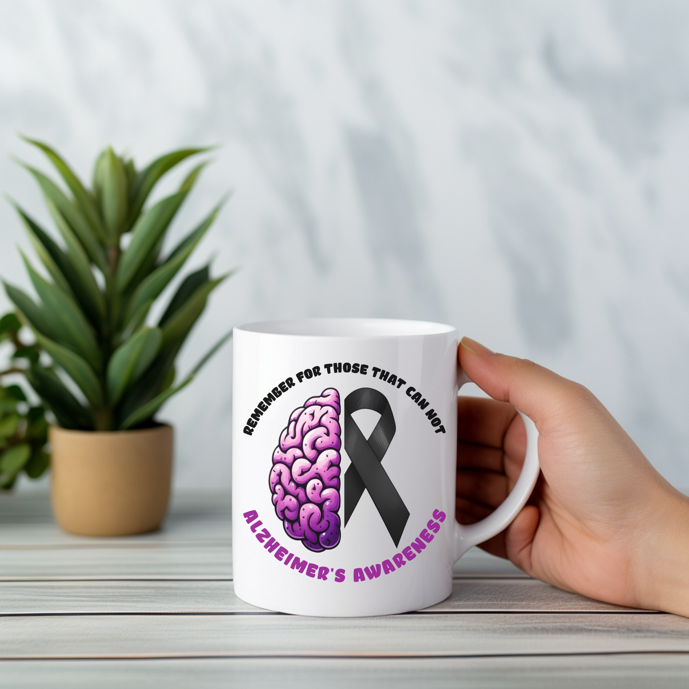 a person holding a coffee mug with a brain cancer ribbon on it