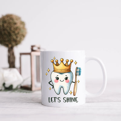 a coffee mug with a toothbrush and a crown on it