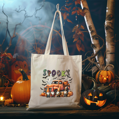 a white bag sitting on top of a table next to pumpkins