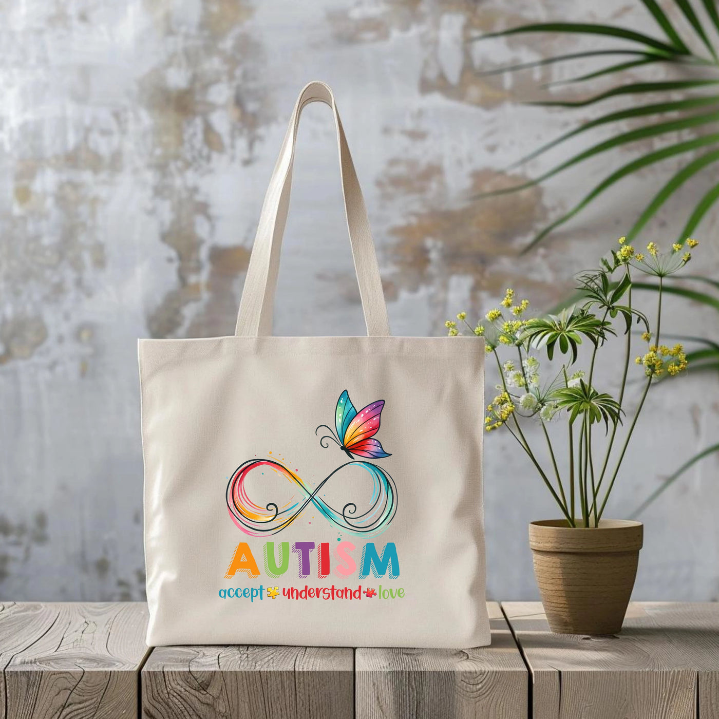 a canvas bag with a butterfly and the word autism on it