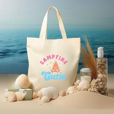 a tote bag sitting on top of a sandy beach