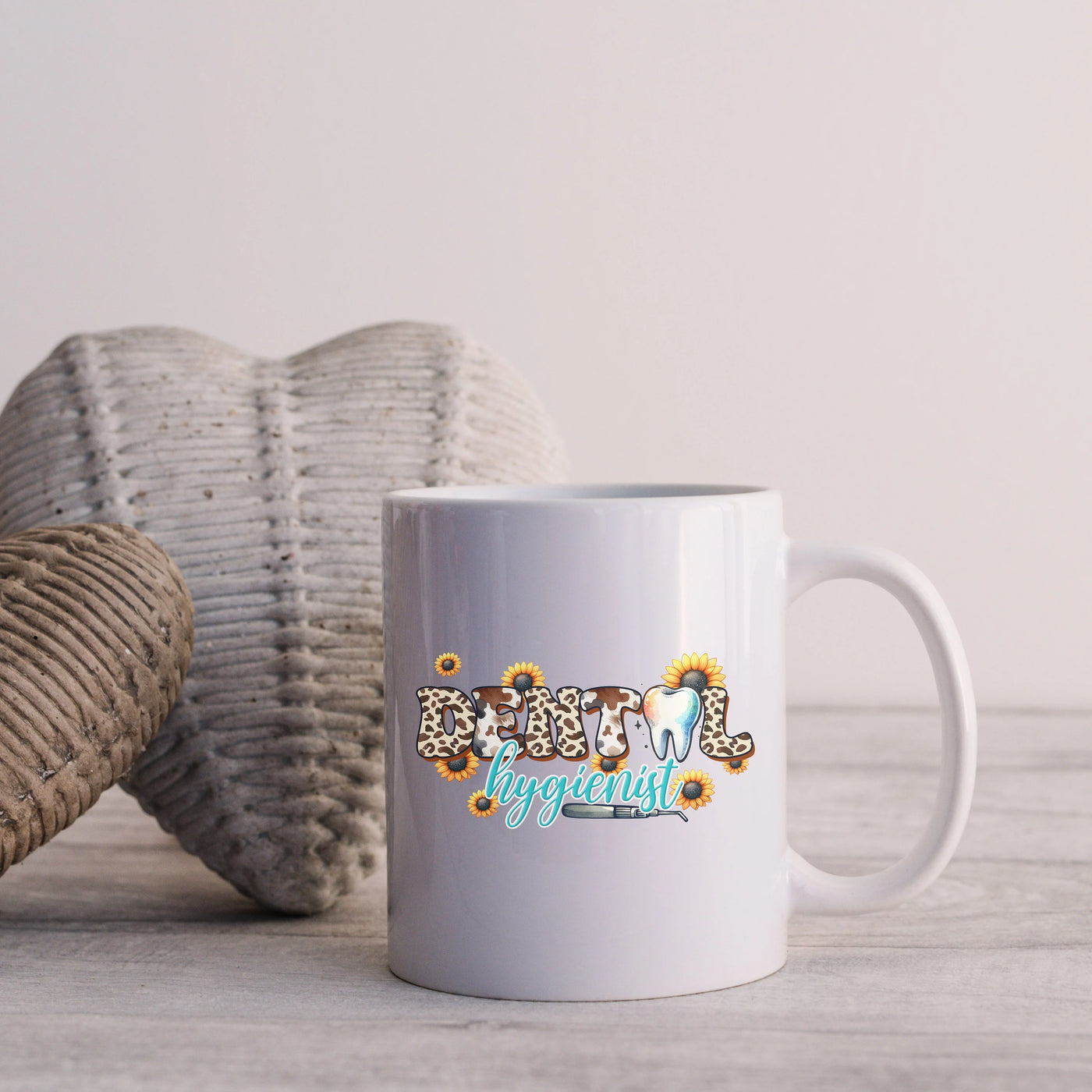 a white coffee mug sitting on top of a wooden table