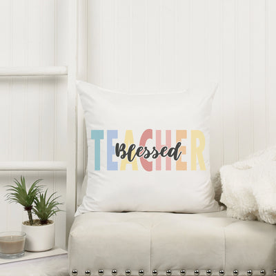 a white couch with a pillow that says teacher on it