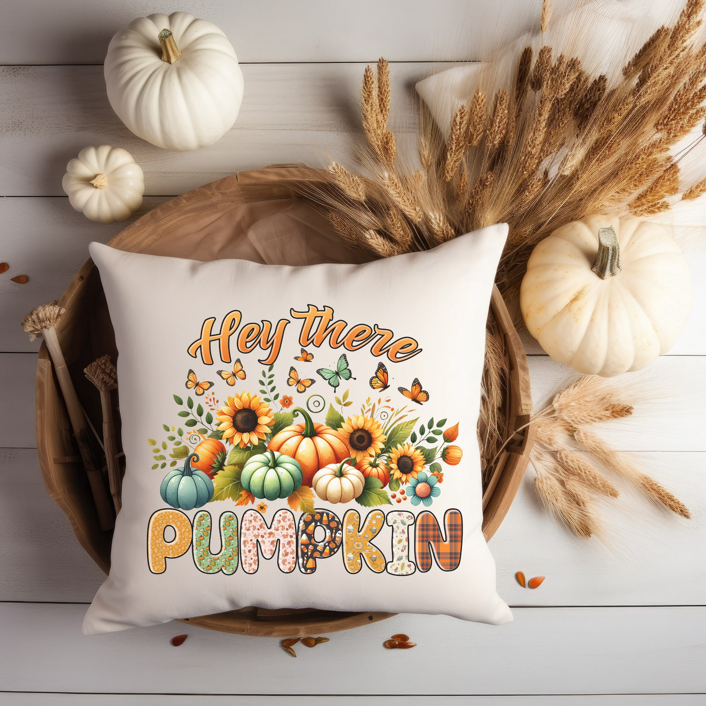 a white pillow with a pumpkin and sunflowers on it