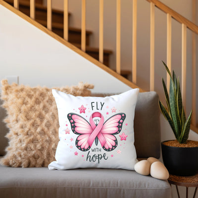 a pink butterfly pillow sitting on top of a couch