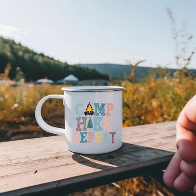 a person holding a coffee mug on a wooden table