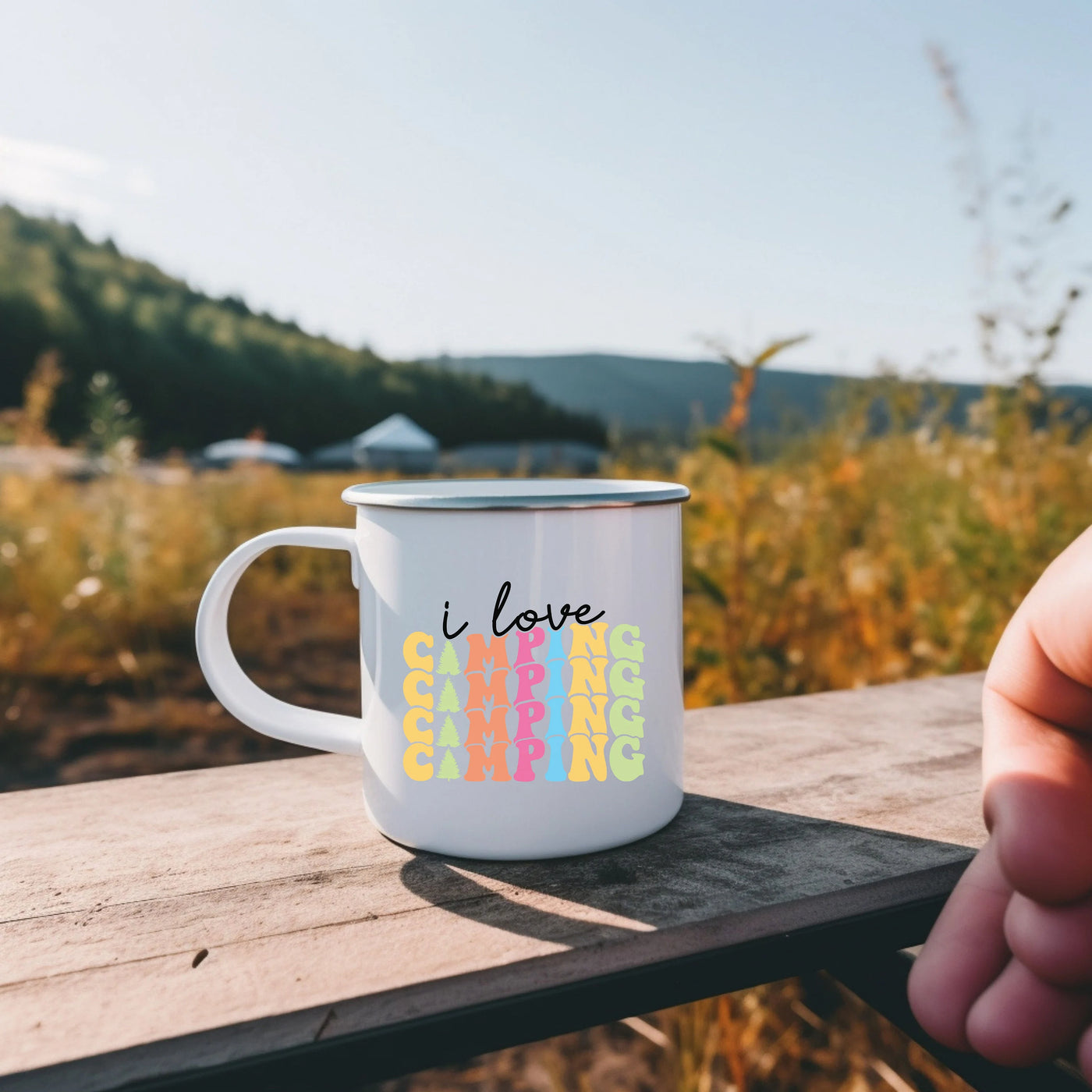 a person holding a coffee mug with the word i love on it