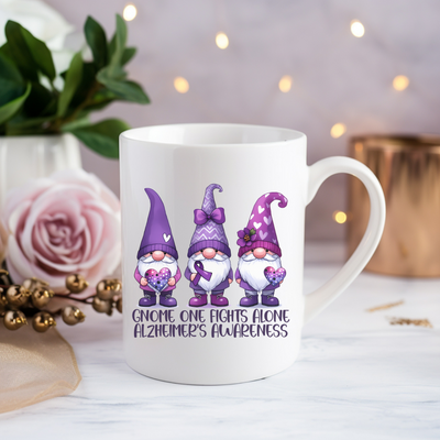 a white coffee mug with three gnomes on it