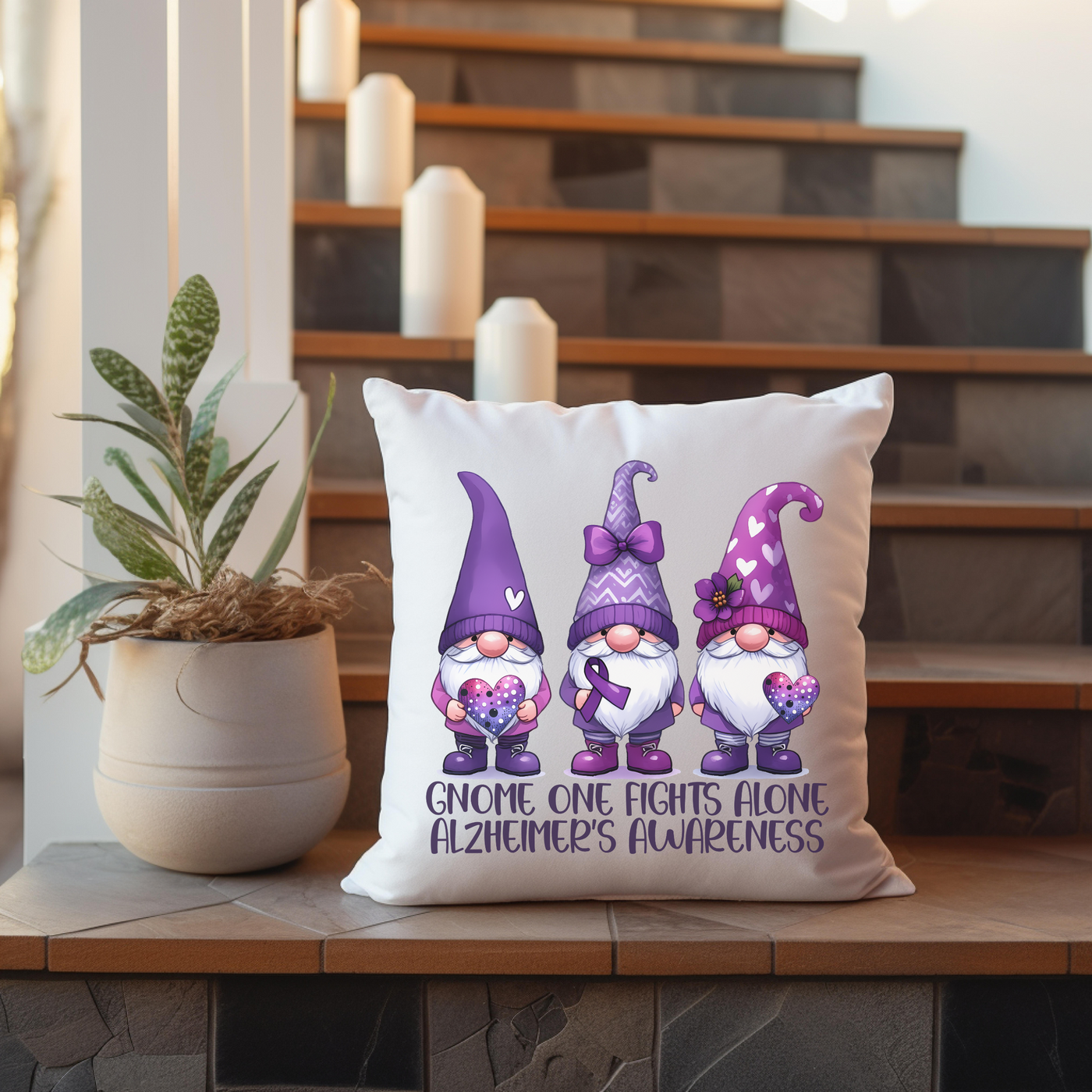 a pillow with three gnomes on it next to a potted plant