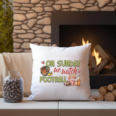 a white pillow sitting on top of a couch next to a fire place