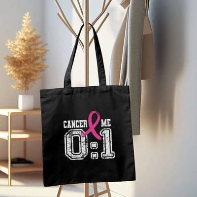 a black tote bag with a pink ribbon on it