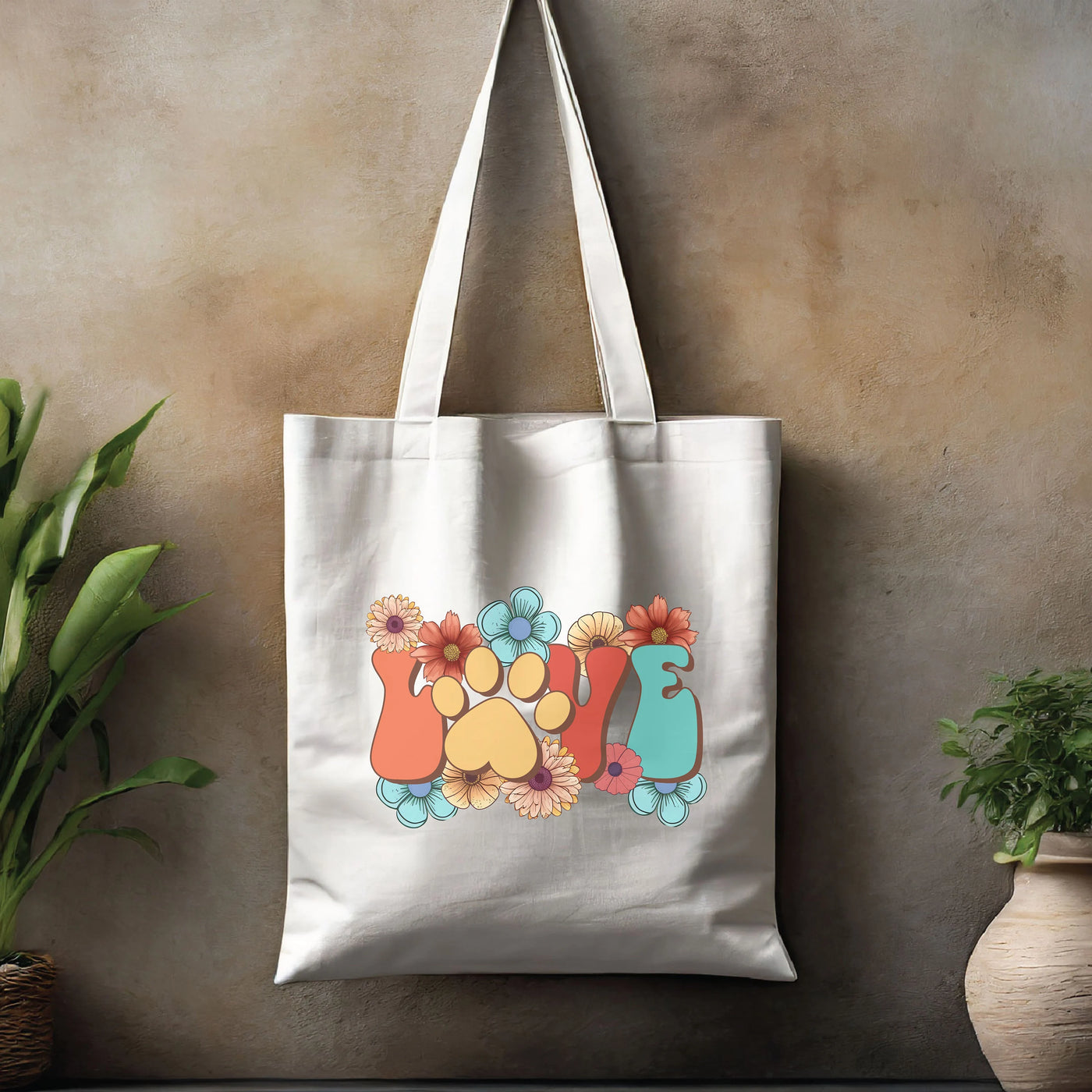 a tote bag hanging on a wall next to a potted plant