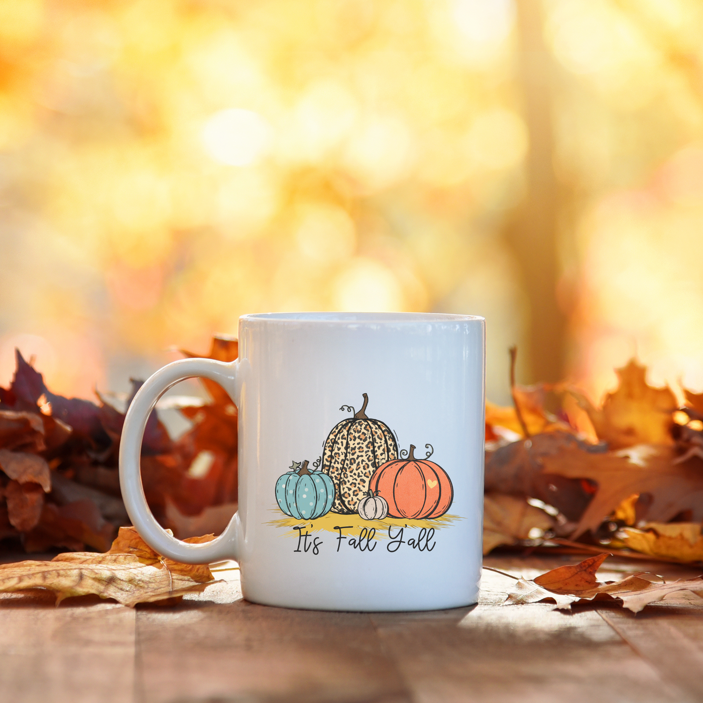 a white coffee mug sitting on top of a wooden table